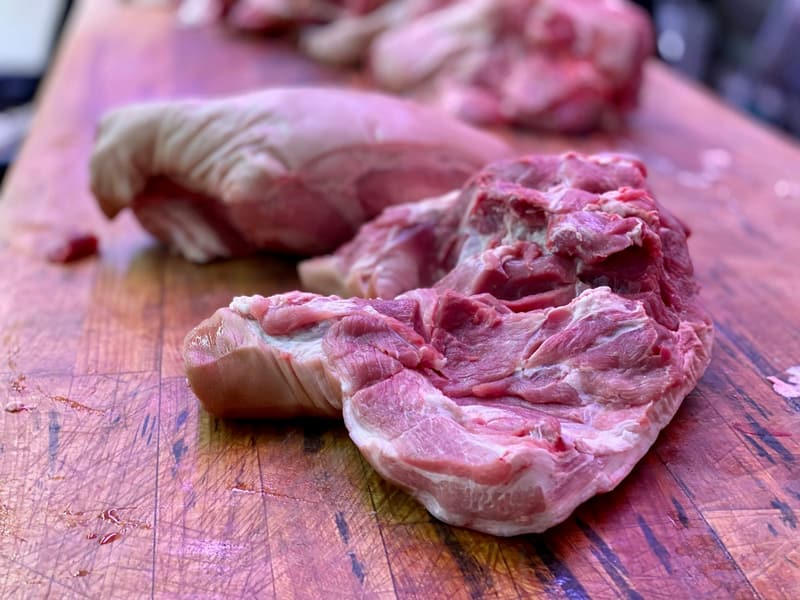 Raw pork shoulder meat on a butcher’s block